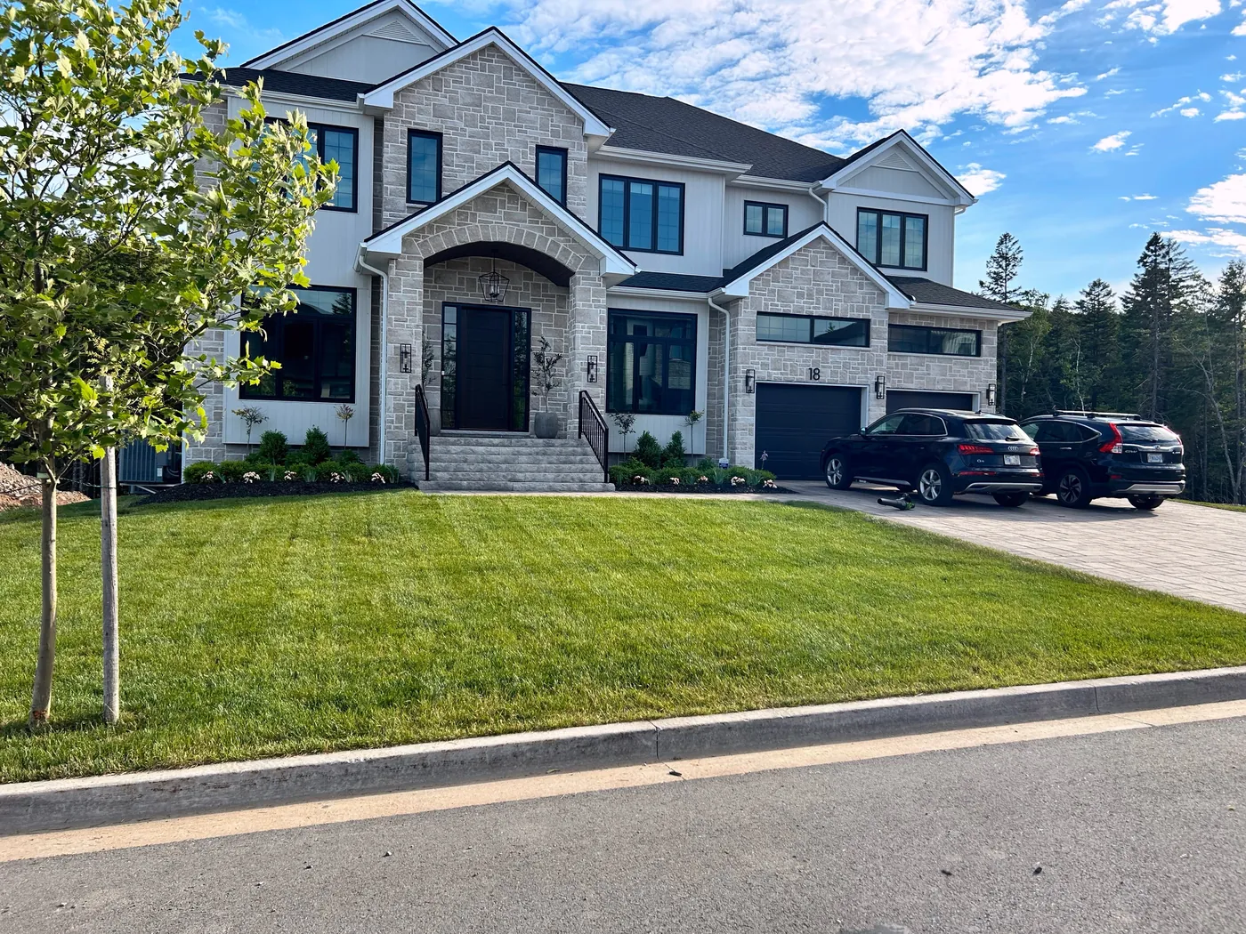 Luxury stone home with full front yard professional landscaping and manicured lawn — Dunbrack's Outdoor Services, Halifax NS